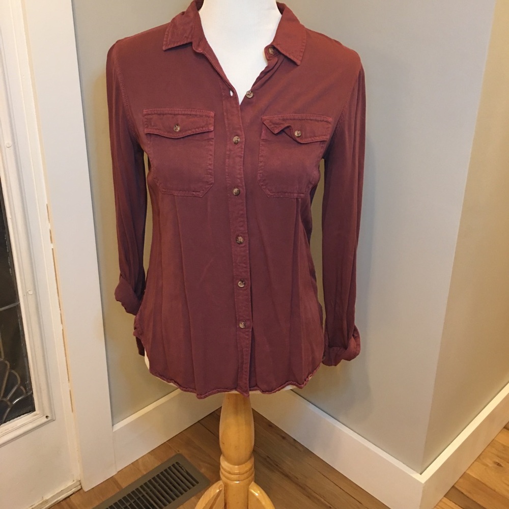 Burgundy button down shirt with breast pockets.